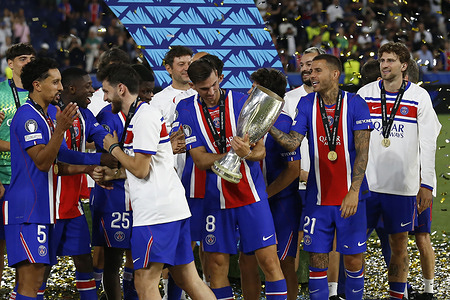 Fabian Ruiz of Paris Saint-Germain holds a trophy surrounded by smiling teammates celebrate their victory during the UEFA Super Cup match between Paris Saint-Germain and Aston Villa at Red Bull Arena. Final score; Paris Saint-Germain 2 : 1 Aston Villa.