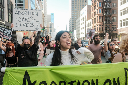 Protesters hold placards, chant, and march through downtown Detroit in support of Roe v Wade. Pro-choice activists march through the streets of downtown Detroit, Michigan to protest a leaked document that showed that the U.S Supreme Court was prepared to overturn Roe v. Wade.