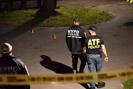 Federal agents with the ATF and officers with the NYPD work at the scene where one person was killed and four people were injured in a mass shooting in the area of Burke Avenue and Wickham Avenue, Haffen Park within the confines of the 47 Precinct in Bronx, New York, United States. Saturday evening in Haffen Park a mass shooting took place. A 32-year-old man was shot to the chest and pronounced dead, a 30-year-old man was shot to the back and was originally listed in critical condition, a 17-year-old girl was shot to the face and was originally listed in critical condition, a 29-year-old woman was shot to the back and is listed in stable condition and a 42-year-old man was shot to the arm and is listed in stable condition. One gun was found at the scene. The New York City Police Department is investigating the shooting.