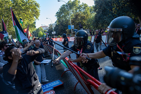 A group of riot police clash with protesters during the demonstrations in Madrid, while the 21st stage of the Vuelta a España was canceled. The Vuelta a España was marked by protests in support of the Palestinian people.