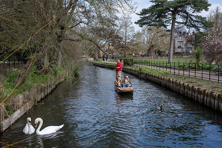 Tourists travel by a flat-bottomed boat called a punt on the River Stour in Canterbury. Canterbury is a city in the county of Kent, England. It lies on the River Stour and the population is 55000. Canterbury is a popular tourist destination, with the city's economy heavily reliant upon tourism, alongside higher education and retail.