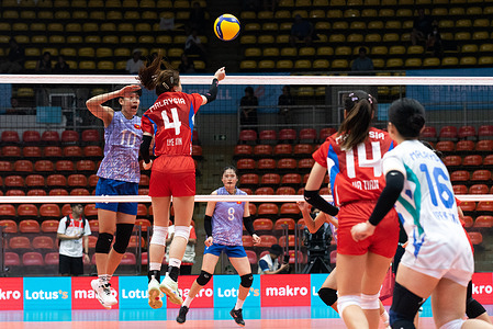 Le Nhu Anh #10 of Vietnam and Lum Lye Xin #4 of Malaysia seen in action during the Women's Volleyball group stage against Malaysia in 33rd SEA Games at Indoor stadium Huamark in Bangkok. Final score ; Vietnam won over Malaysia 3 : 0 (25:8,25:5,25:3)
