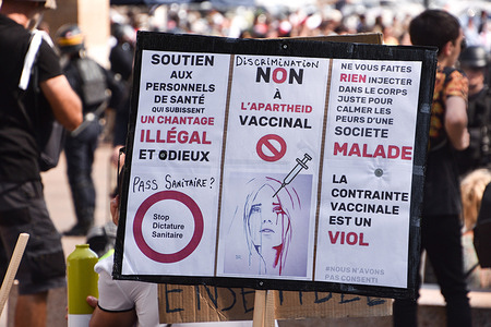 A protester holds a placard during the demonstration against the health pass in Marseille.More than 4,000 people in Marseille demonstrated against a "health pass" that French President Emmanuel Macron announced among the new anti-Covid 19 measures which will be necessary to be frequenting café terraces, restaurants, cinemas, theatres and other culture and leisure activities to help contain the spread of the Covid-19 virus.