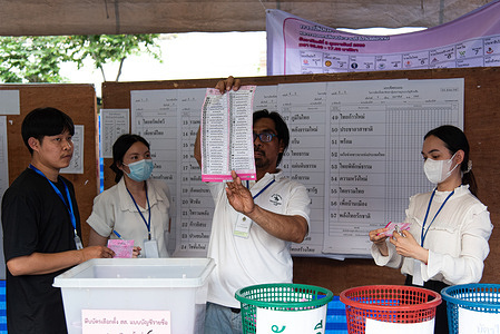 Thai poll station officials count votes at a polling station at Wat That Thong during Thailand general election in Bangkok.