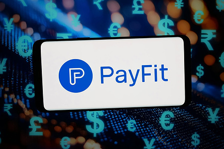 In this photo illustration, the logo of payroll software company Payfit is displayed on a smartphone in front of abstract background on computer screen.