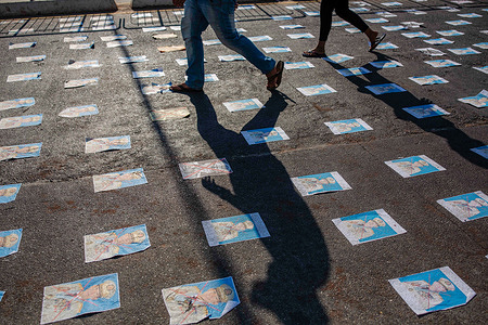 Portraits of Myanmar military general, Min Aung Hlaing seen laying on the ground during a demonstration against the military coup.Myanmar police and military fired rubber bullets, tear gas and sound bombs at peaceful anti-military coup protesters. Several were arrested and injured including rescue volunteers, but the exact number is still unclear.Myanmar's military detained State Counsellor of Myanmar Aung San Suu Kyi on February 01, 2021 and declared a state of emergency while seizing the power in the country for a year after losing the election against the National League for Democracy (NLD).