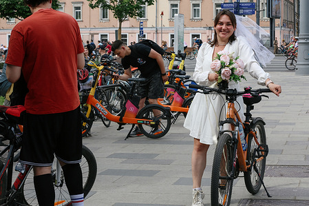 A participant wearing bride's costume seen during Moscow Bike Festival. Moscow bicycle festival marked start of summer outdoors season and brings together more than 60 thousand people on the Garden Ring Road (called Sadovoe Ring) in the center of Moscow.