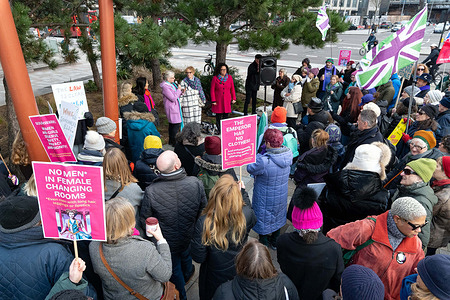 Protesters gathered for speeches during the demonstration. Women gathered outside The Castle Leisure Centre in London to protest after Miranda Newsom was banned from the council-run facility following a dispute over access to the women’s changing rooms. Demonstrators said the ban followed Newsom raising concerns about a transgender woman using the female changing area, and they argued the decision restricted women’s ability to voice concerns about single-sex spaces. Protesters held placards and held speeches outside the venue, calling on the local council and leisure operator to review the ban and clarify policies governing access to women-only facilities.