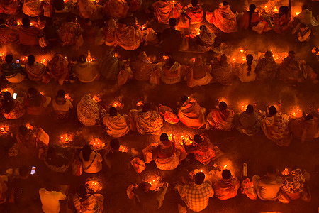 Devotees offer prayers by lighting oil lamps and incense sticks to Sri Loknath Brahmachari on the occasion of Karthik Brata at Chakla Dham Loknath Brahmachari ashram. Rakher Upobash is a Hindu religious festival of lights, faith, and devotion. According to the Hindu calendar, it usually takes place in the month of Kartik, which typically falls in November. Kartik month is an auspicious time according to Hindu religion. Devotees fast from sunrise and offer prayers to Sri Loknath Brahmachari during sundown before breaking their fast. The festival is usually celebrated in Bangladesh and certain parts.
