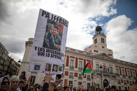 A protester holds a placard during a demonstration. The Solidarity Network Against the Occupation of Palestine has called for a demonstration in Madrid to denounce "the genocide in Palestine" and the arms trade with Israel, at a time when Benjamin Netanyahu's government is intensifying its operations in Gaza and the West Bank.