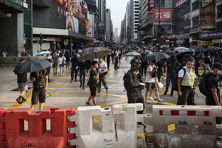 Protesters march while holding umbrellas during the demonstration.
Hong Kong has been shaken for over four months of massive anti-government demonstrations. Despite the face mask ban and subsequently arrests, protesters have continued to march the streets of Kowloon district following a violent weekend of unrest which also crippled the city's train network.