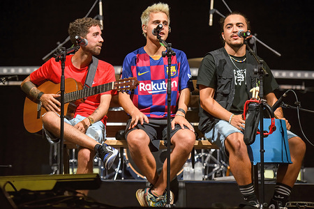 (L of R) Rai Benet, Klaus Stroink and Guillem Boltó of the Stay Homas musical group perform at Festival de El Vendrell.
The Spanish music group Stay Homas performs at the Vendrell Festival in front of 800 people seated and wearing protective masks, observing the prohibition of dancing and eating due to the Covid-19 health crisis. Stay Homas, musical group was created and popularized during the confinement of the state of alarm in Spain during 2020 for their music videos from the terrace of their house for fun and to encourage people they published on the YouTube platform.