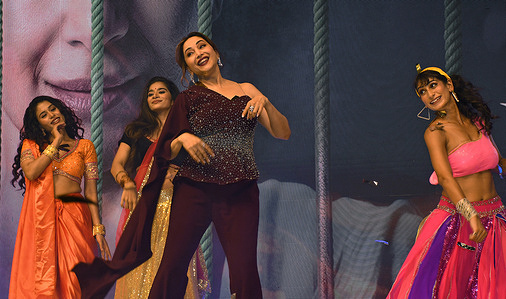 Bollywood actress Madhuri Dixit Nene (c) dances during the trailer launch of her upcoming web series Mrs. Deshpande in Mumbai. The psychological thriller web series will premiere on the JioHotstar on 19th December 2025.