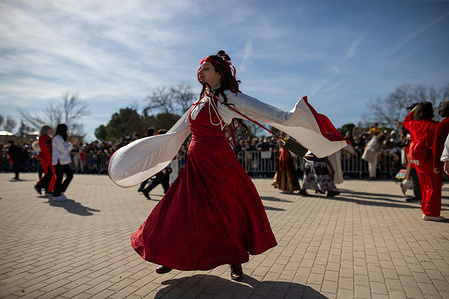 A woman participates in the parade during the Chinese New Year of the Horse celebration. The Chinese community residing in Madrid celebrated the Chinese New Year of the Fire Horse in Pradolongo Park in the Usera district.