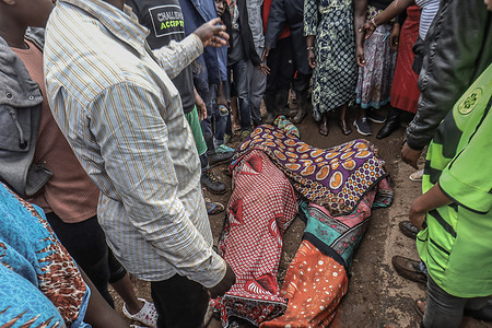(Editors note image depicts death)
Residents from Kibera Slums viewing the bodies of the two motorcyclists who died from the heavy flooded river Mutuine in Kibera Slums.
Residents of Kibera Slums living close by Mutuine River were left homeless after the heavy floods that occurred on May 13th, Thursday night. At least four residents died including two young motorcyclist who were trying to cross over the river late at night whose corpses were found nearby the ongoing bridge construction.