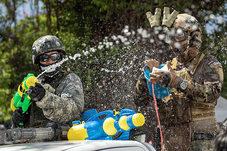 Revelers wearing military attire are seen during the celebration of the Songkran Festival 2025 in Chiang Mai.
