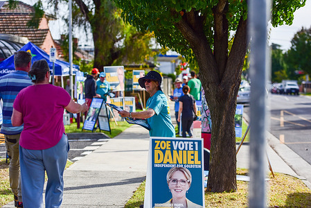 Independent candidate's volunteer seen handing out flyers at the polling station during Australian Federal Election.