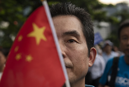 Portrait of a pro-China supporter holds a Chinese national flag during a rally in support of the government and police in Hong Kong.
Thousands of Pro Beijing supporters rallied near the government's headquarters in Hong Kong in the name of protecting Hong Kong and supporting the police to take action to stop the anti government protests in Hong Kong. Since early June there has been weekly anti government protests taken place in Hong Kong demanding the government to withdrawal the controversial extradition bill.