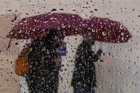 Pedestrians carry umbrellas in the rain in Los Angeles. Snow, rain and hail fell across the South California today as a winter storm with an intensity not seen in decades slammed the region, leading to flooded streets and a nearly all-day closure of the Grapevine that made driving a generally miserable experience across the area.