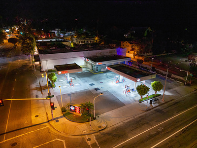 An aerial view of Ralphs Fuel Center at the intersection of Washington Boulevard and Lincoln Avenue during overnight hours. Fuel prices are displayed at the station as motorists navigate rising transportation costs and ongoing concerns over energy prices across Southern California.