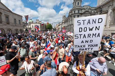 A protester holds a placard saying "stand down starma (Keir Starmer) and take your party" during the rally. Protesters gathered at Russell Square and marched to Downing Street in London demanding the UK government to “stop the grooming gangs” and calling for justice for the victims. The rally, organized by Football Lads Against Grooming Gangs and Together For The Children, was to voice anger at alleged systemic failures to protect children.