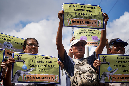 Members of faith community gather with placards as they await to deliver more than 75,000 signatures against mining to the Salvadoran Legislative Assembly during a demonstration in San Salvador.
