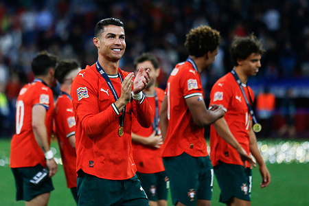 Portugal's Cristiano Ronaldo walks across the pitch with the gold medal after the award ceremony. Portugal 2–2 Spain (Portugal win 5–3 on penalties)