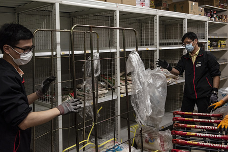 Supermarket employees wear surgical masks while replenishing rice goods after stock has been sold out in Hong Kong due to preventative measure after a Wuhan's Coronavirus outbreak spread across Southeast Asia.