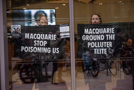 Protesters hold placards during the demonstration inside the premises of the Macquarie Group. Members of Extinction Rebellion targeted the Macquarie Group building in central London during a protest. Macquarie Group is an Australian multinational investment banking and financial services company and the owner of Farnborough Airport, which focuses on private and business aviation. Demonstrators opposed the airport’s planned expansion, citing environmental and climate concerns linked to increased business jet activity.