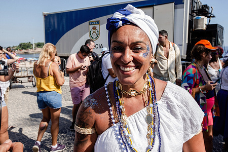 A maracatu dancer prepares for the event. In the event modeled after the celebrations on the Rio Vermelho in Salvador, Cariocas honored Iemanjá, the west-African goddess of the sea. The festival praised Brazil's most well-known deity with jongo, afoxé, samba, and maracatu music and dances, uniting centennial traditions from both communities, Umbanda and Candomblé. The event was held in Arpoador, Rio de Janeiro, for the first time, idealized by the musician Marcos André.