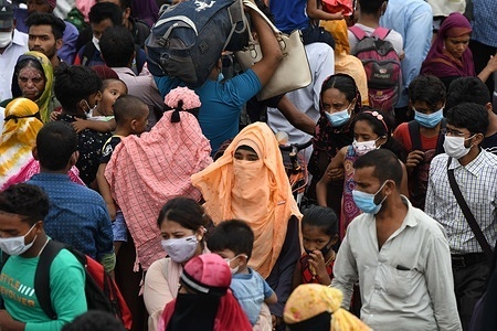 Migrants and other people returning to their native homes crowd to board a ferry as authorities ordered a new lockdown to contain the spread of Covid-19 coronavirus in Munsiganj outskirt of Dhaka.