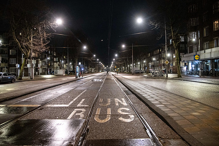 A view of an empty street in Amsterdam as strict curfew was imposed by the Dutch government to prevent and combat the spread of COVID virus.Police were deployed on the streets of Amsterdam for the night-time curfew that is applied from 21:00 local time until 04:30. The new Covid-19 mutation helps the infection number rise. The Dutch police is checking citizens for proper documents, permit from employers in order to be out after the curfew time. Most of the roads are empty after 21:00, deserted while public transportation vehicles are empty. The Netherlands faced some violent protests the previous days against the strict lockdown measures.