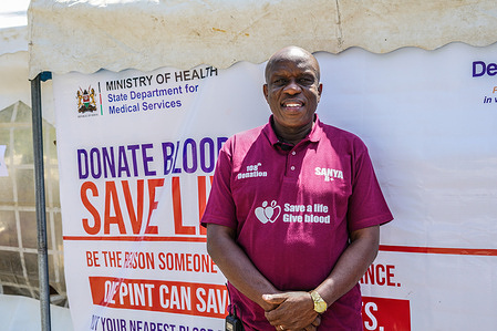 Sanya Alpha Kennedy, Kenya’s top blood donor, and ambassador, poses for a photo as participants donate blood in the background during this year’s World Blood Donor Day commemorations in Nakuru. World Blood Donor Day is commemorated on 14th June every year to raise global awareness about the need for safe, regular, and voluntary blood donations and to thank blood donors like Sanya Alpha Kennedy, Kenya’s top blood donor who give freely and regularly to help many people in dire need of blood products for survival.