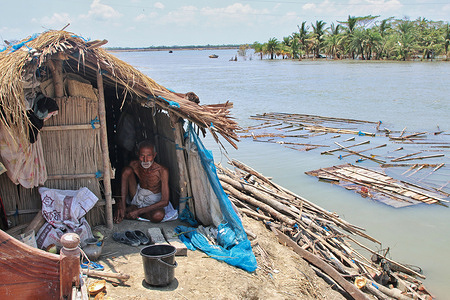 A man sits under a temporary shelter on the embankment during the aftermath of the cyclone amphan.
Thousands of shrimp enclosures have been washed away, while numerous thatched houses, trees, electricity and telephone poles, dykes and croplands were damaged and many villages were submerged by the tidal surge of the extremely severe cyclonic storm amphan in Khulna division.