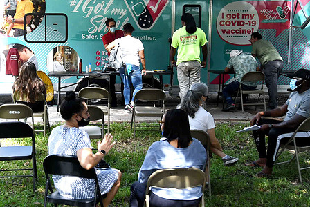 People wait in the observation area at a mobile COVID-19 vaccination site.
New COVID-19 cases in Florida have doubled in the past week, with most cases identified as the highly contagious delta variant which is surging across the country.