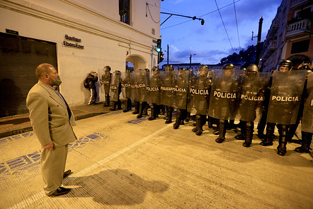 A protester dressed in a suit rebukes a police wall during the demonstration. Several groups of demonstrators protest in Quito against the government of Guillermo Lasso due to the rise in fuel prices and several other policies that have affected the country's economy, this is the third day of protests and indigenous uprising in Ecuador.