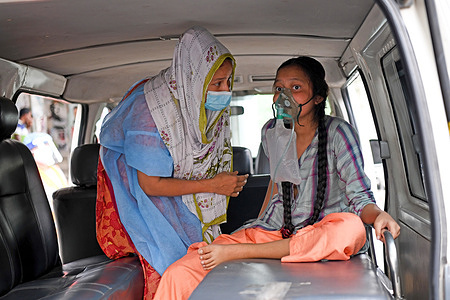 A Covid-19 patient is being taken to Dhaka Medical College Hospital with her family members for treatment in Dhaka.Bangladesh extends nationwide lockdown measures until May 05 and imposed a nighttime curfew to prevent further spread of COVID-19.