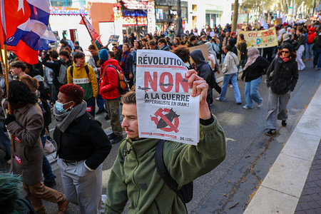 A protester holds up a "No to war" placard during the demonstration. Hundreds of high school students and teachers marched in Marseille to protest education budget cuts. The demonstration, organized by unions, targeted the local education authority (DSDEN) to demand more resources and oppose austerity measures. Protesters warned that the budget could cut around 40 teaching positions and lead to class closures and overcrowding. The movement has intensified in the city, with previous school blockades and some police intervention.