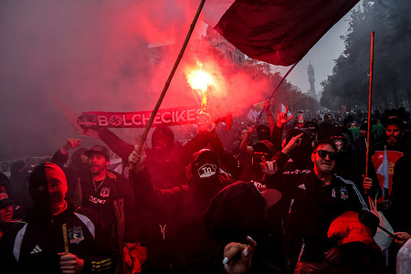 A group of protesters light a flare during a march for Labor Day. Hundreds of people marched for Labor Day, May 1st, in the city of Santiago, Chile.
