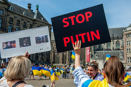 A Ukrainian woman is seen holding a placard against Putin during the demonstration. The Ukrainian community in The Netherlands gathered at the Dam square in Amsterdam to demand the extraction of the Ukrainian soldiers trapped in Mariupol’s Azovstal steel plant. Ukraine’s Azov battalion that has led the defense of Mariupol has posted desperate videos from the plant, saying soldiers are dying from their wounds there.