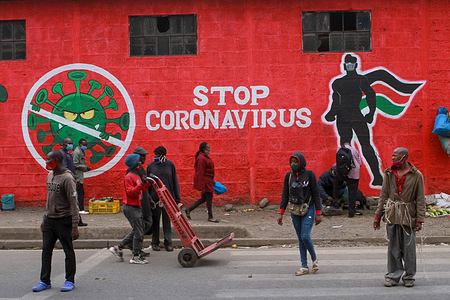 Kenyans walk past an informative mural about the Coronavirus along Haile Selassie avenue in Nairobi. Kenyans have made creative ideas of informative messages in murals, skits, face masks, songs and many more since the first case of covid-19 was confirmed.