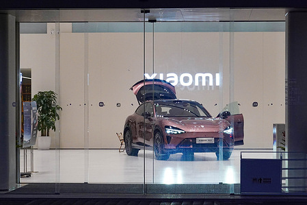 A Xiaomi SU7 seen on display inside the store with doors open and 'Xiaomi" logo on displayed on the wall. Xaomi reported that it delivered more than 40,000 cars to customers in China - which is a new record for the company. The new sales data shows how quickly Xaomi is gaining ground in China's competitive EV market.