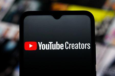 In this photo illustration, the YouTube Creators logo is seen displayed on a smartphone screen.