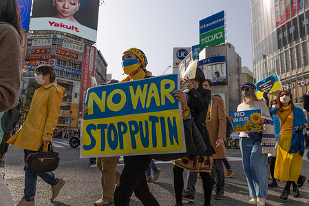 Protesters march while holding placards during the demonstration.Hundreds of people marched in central Tokyo protesting Russia's invasion of Ukraine. With signsdemanding the end of the war and criticizing the Russian presidentVladimir Putin.
