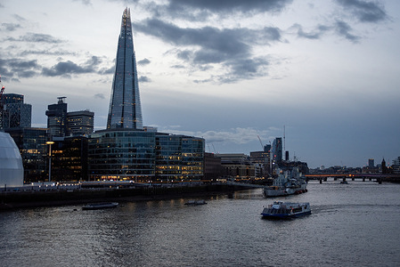 View of The Shard, also referred to as the Shard London Bridge and formerly London Bridge Tower at dusk in London. London is a very popular tourist destination because of the museums, galleries and the historical buildings on the both banks of the River Thames.