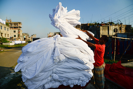 A worker dries fabric under the sun before dyeing them at a factory in Narayanganj.
Most of the time workers dyeing clothes without wearing gloves and it causes skin diseases.