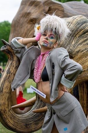 A model showcases Pierre Garroudi's latest colourful collection at one of the weekly designer's specialty flash mob fashion show in central London.
