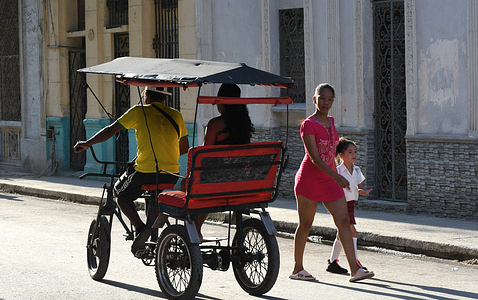 A driver ferries a passenger in Havana, Cuba in a bicitaxi, a pedal-powered three-wheeled rickshaw. The tricycles remain popular as passenger taxis during the severe energy crisis throughout the island nation, the result of a fuel blockade imposed on January 29, 2026 by the United States. The energy crisis has caused power blackouts, transportation interruptions, and shortages of cooking gas.