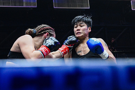 Phannaluk Kongsang (R) and Melina Maibuam (L) trade blows during their 10-round contest for the WBC International super bantamweight title.