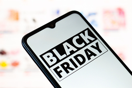 In this photo illustration, the Black Friday logo is seen displayed on a smartphone screen.
